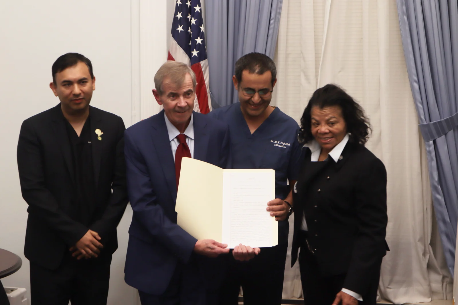 Dr. Mouhab Rizkallah with officials at the Question 2 bill signing at the State House
